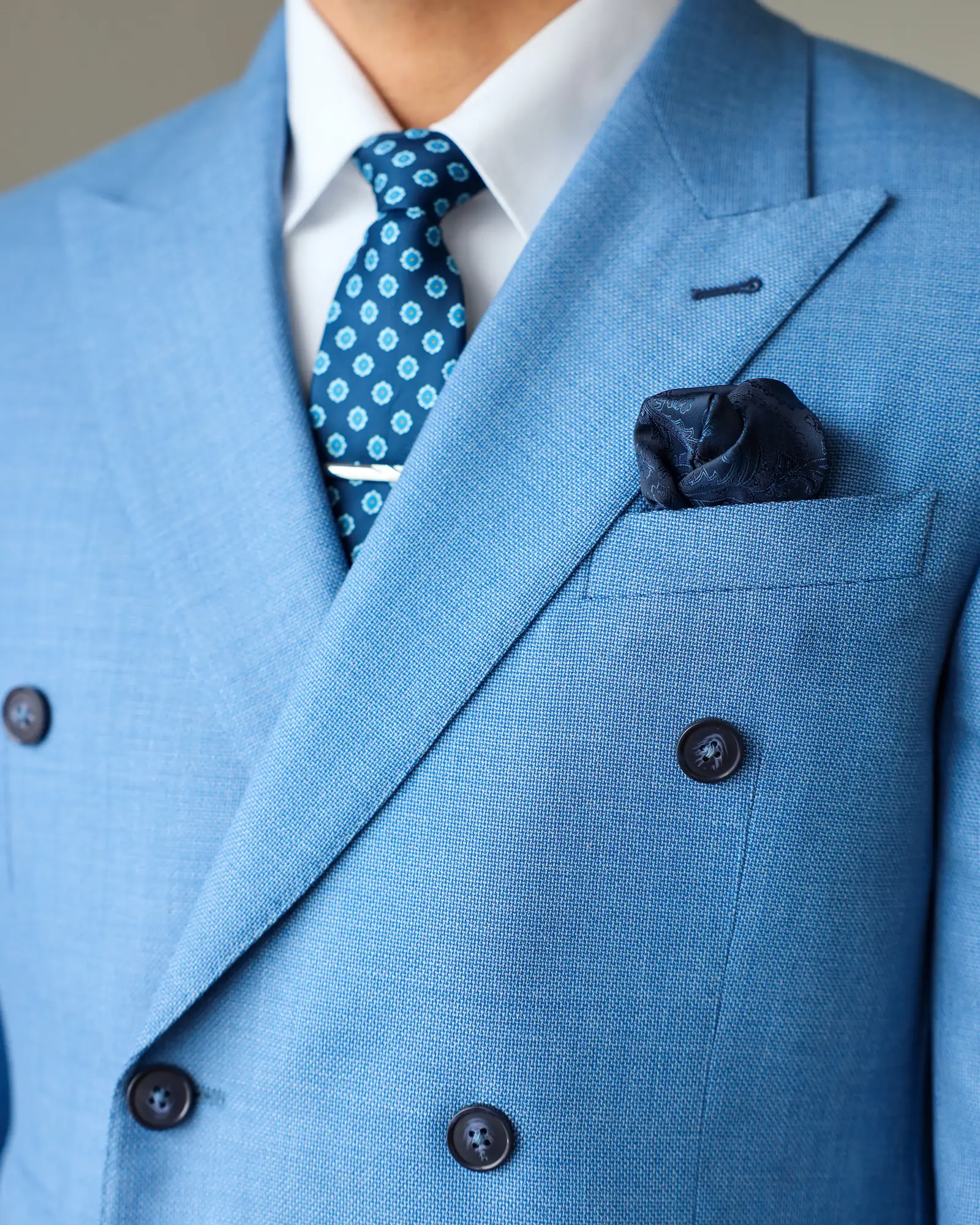 Peak lapel and navy pocket square on the light blue Drago Brera jacket