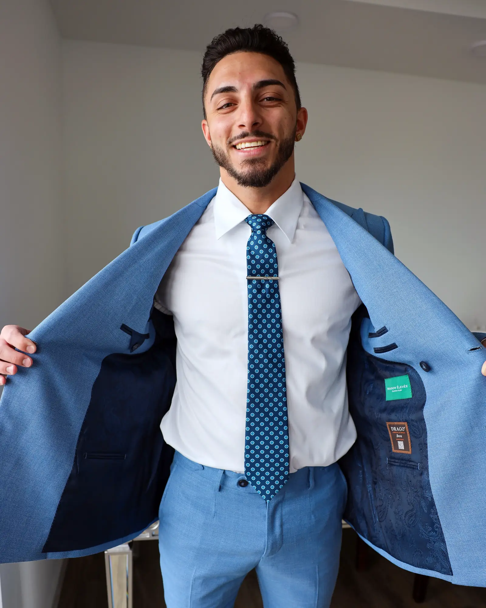 Light blue Drago Brera jacket held open, showing the lining and Drago label
